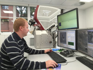 Dr. Will Rickard operating the TESCAN LYRA FIB-SEM.